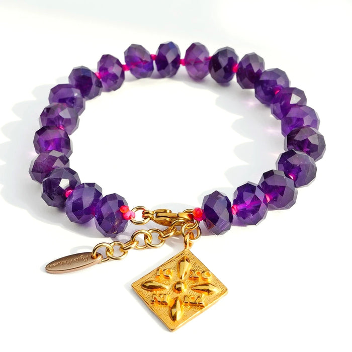 Spirit of Byzantium' Amethyst bracelet featuring knotted purple beads and a gold Byzantine-style charm.